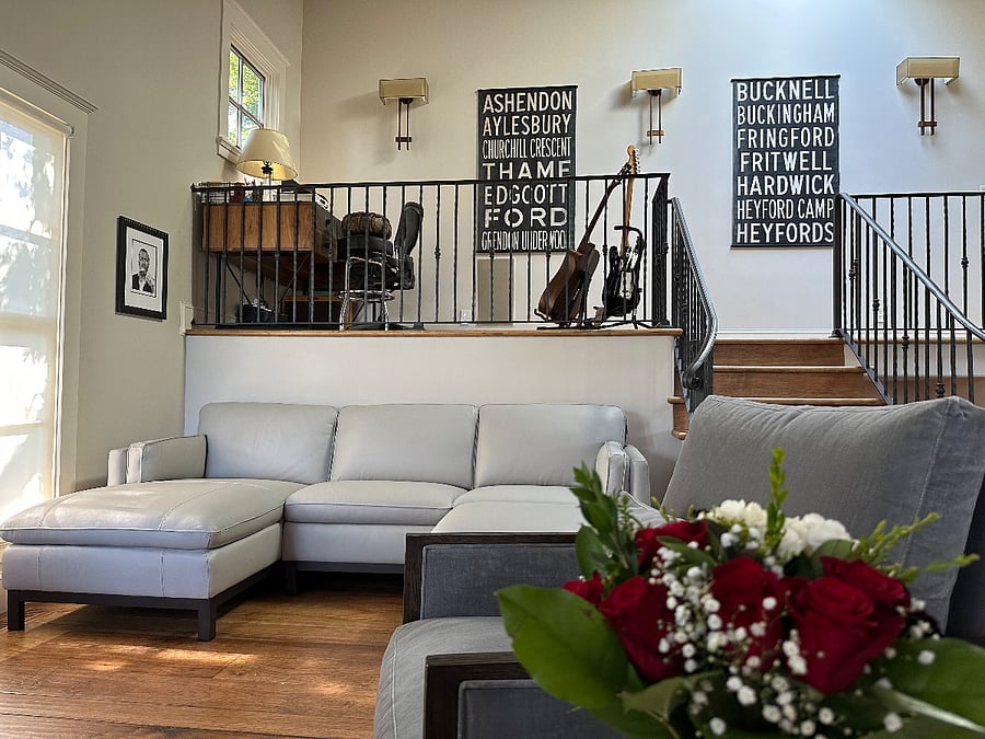 Living room. I don't play the guitar but thought I might one day take lessons. Don't worry - that won't happen! Authentic canvas London bus stops used before the stops became digital. Common living space.
