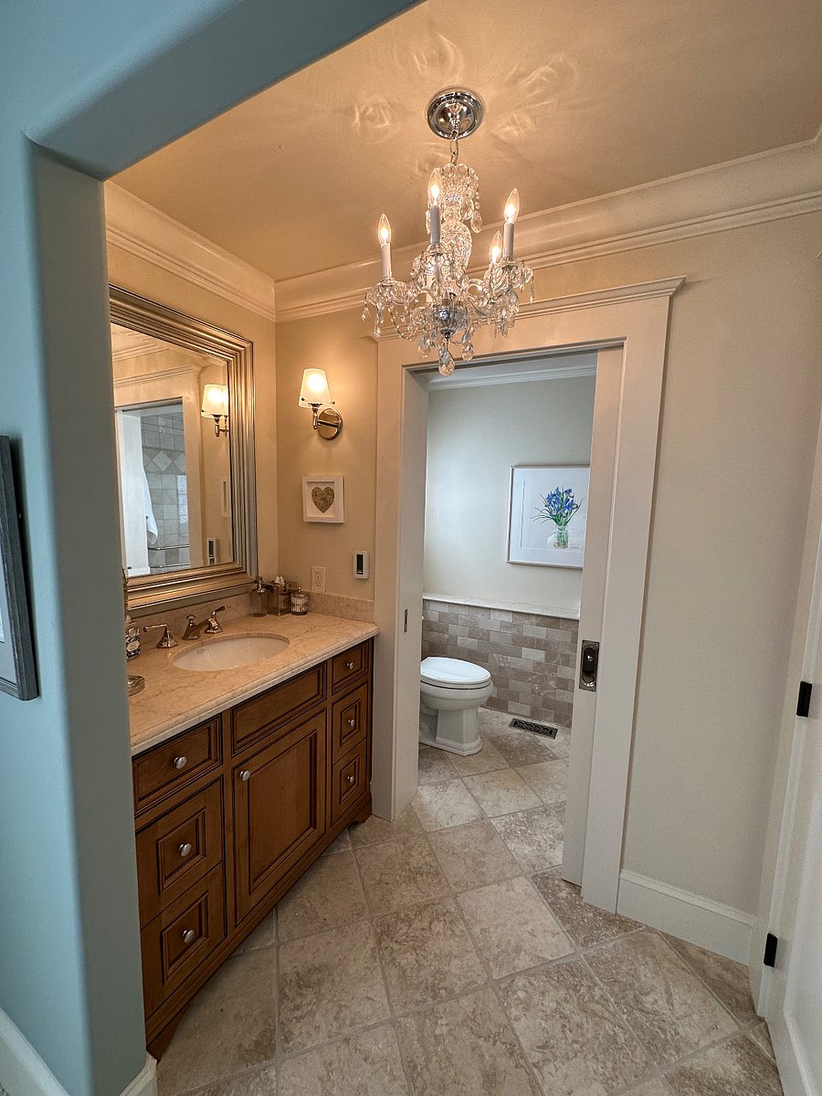 Pocket door closes off toilet and shower from vanity, closet, and bedroom if desired. Chandelier
