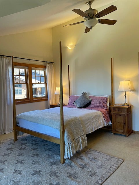 Large bedroom with a small Romeo and Juliette deck overlooking views of the Tualatin Valley and to the Coast Range.