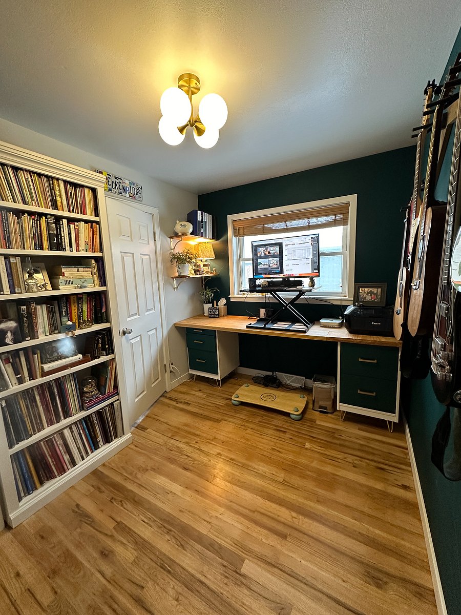 Office with adjustable standing desk. This room could also be used as a nursery.