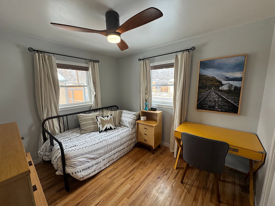 Guest room with bed as twin and desk. This room also has blinds and blackout curtains.