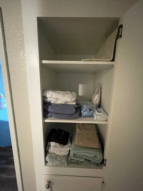Spare linens, a first-aid kit, toiletries, and facial cleaners available in hallway closet