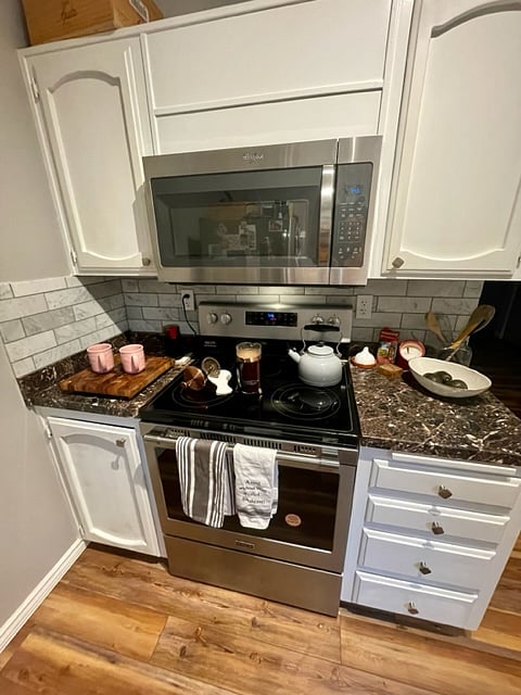Full stocked kitchen with items such as crock pot, cutting boards, measuring cups, and tupper ware. New dishwasher, brand new oven, tons to storage space in the kitchen.