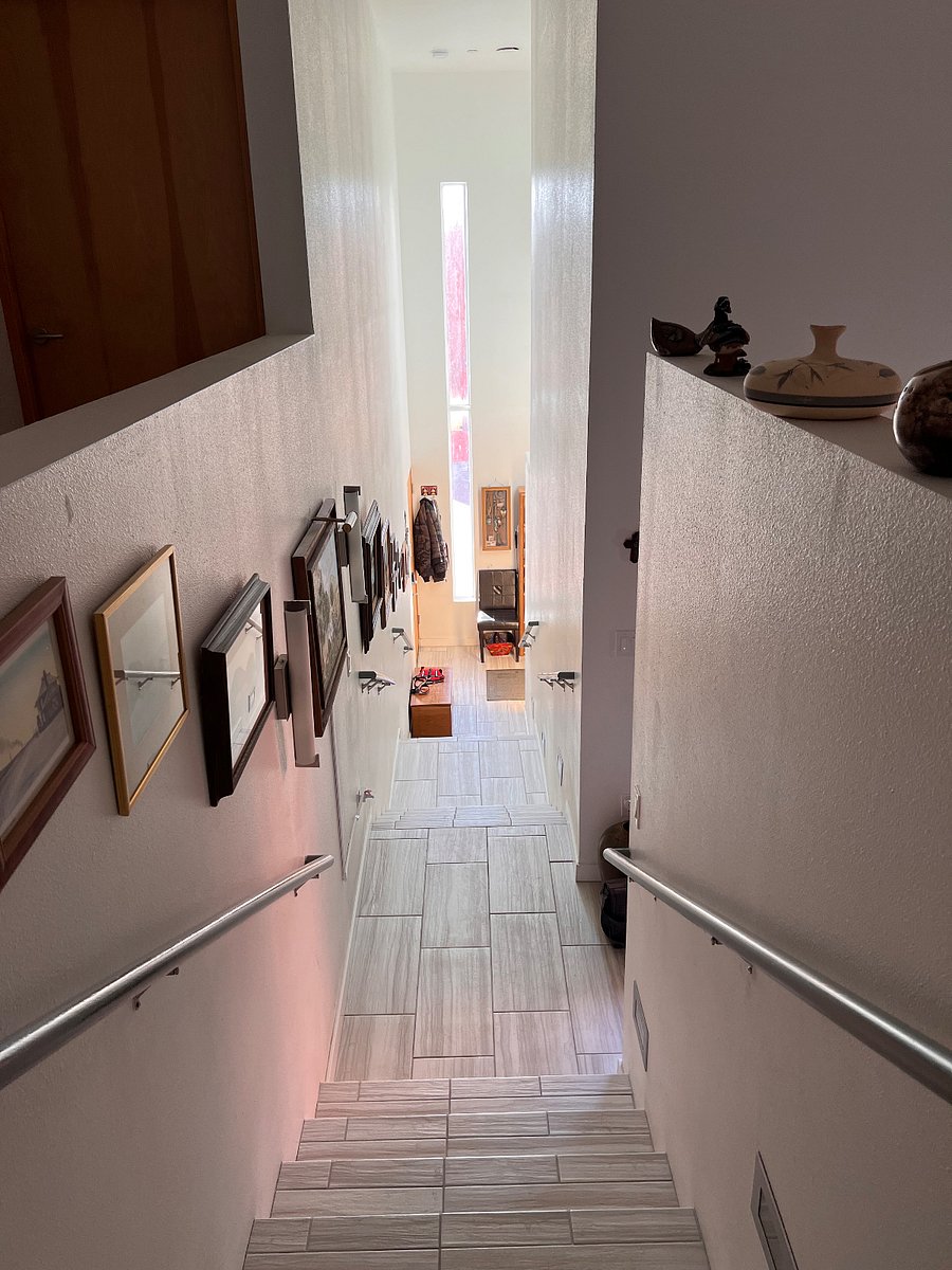 Stairway up from main level to bedrooms and private bathrooms