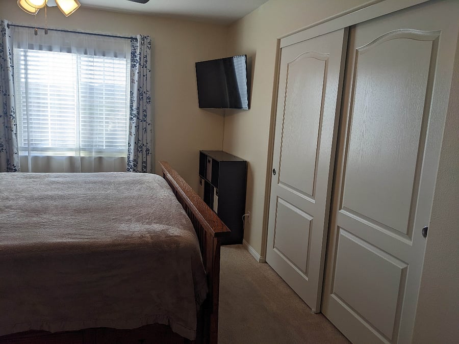 Wall mounted smart TV and closet.