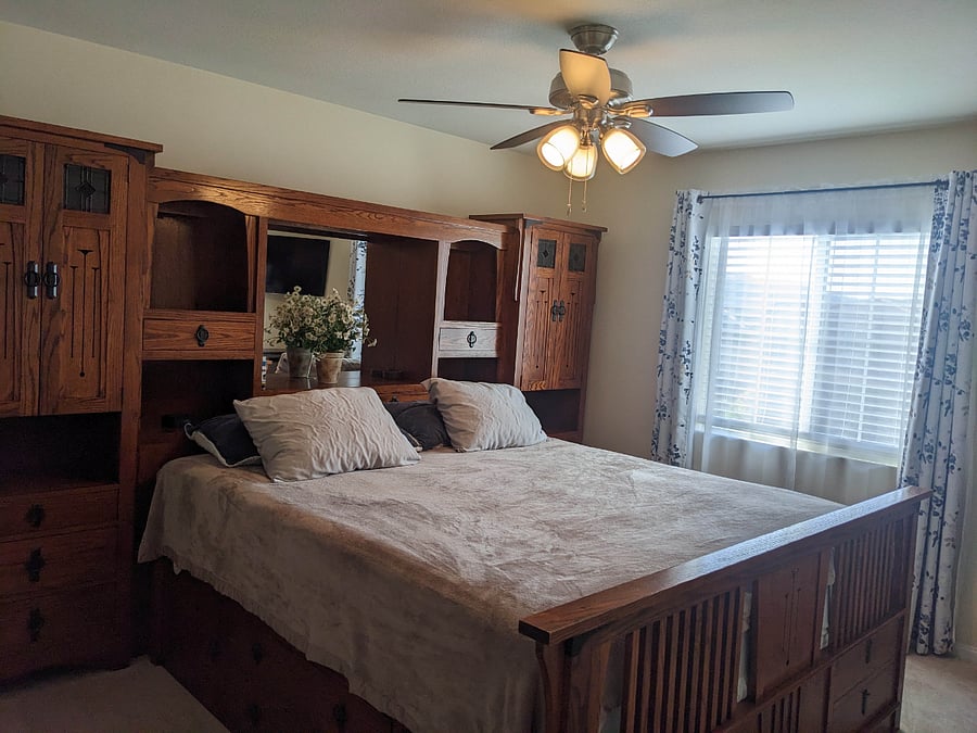 Private room with king sized bed and headboard storage.