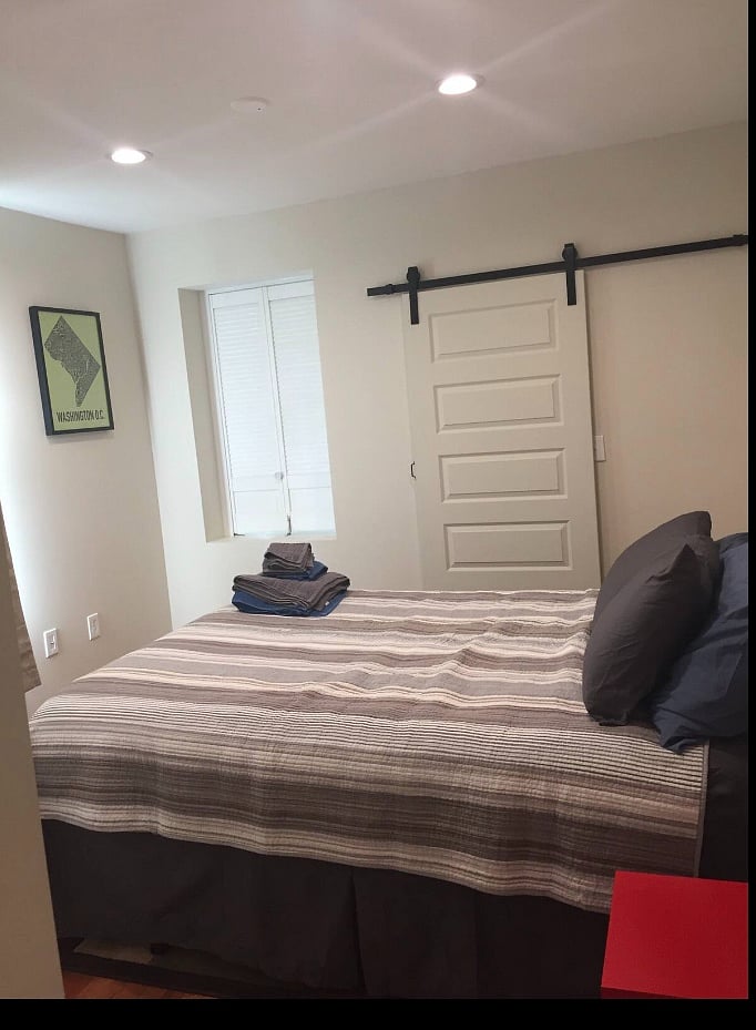 Bedroom features lockable barn-style door leading to rear bedroom that can double as a den.