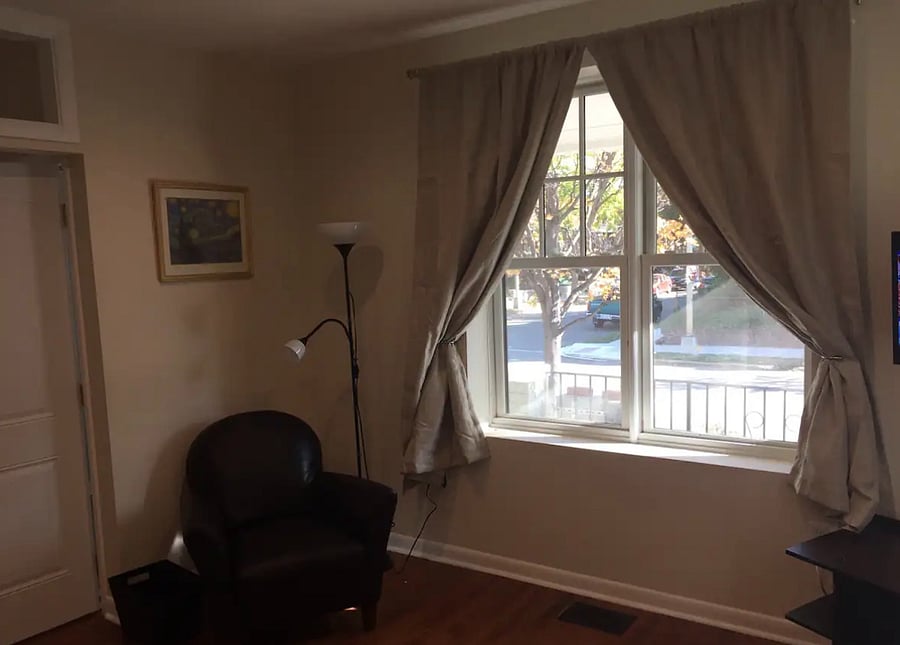 Living Room features large window for light and armchair reading and relaxation.