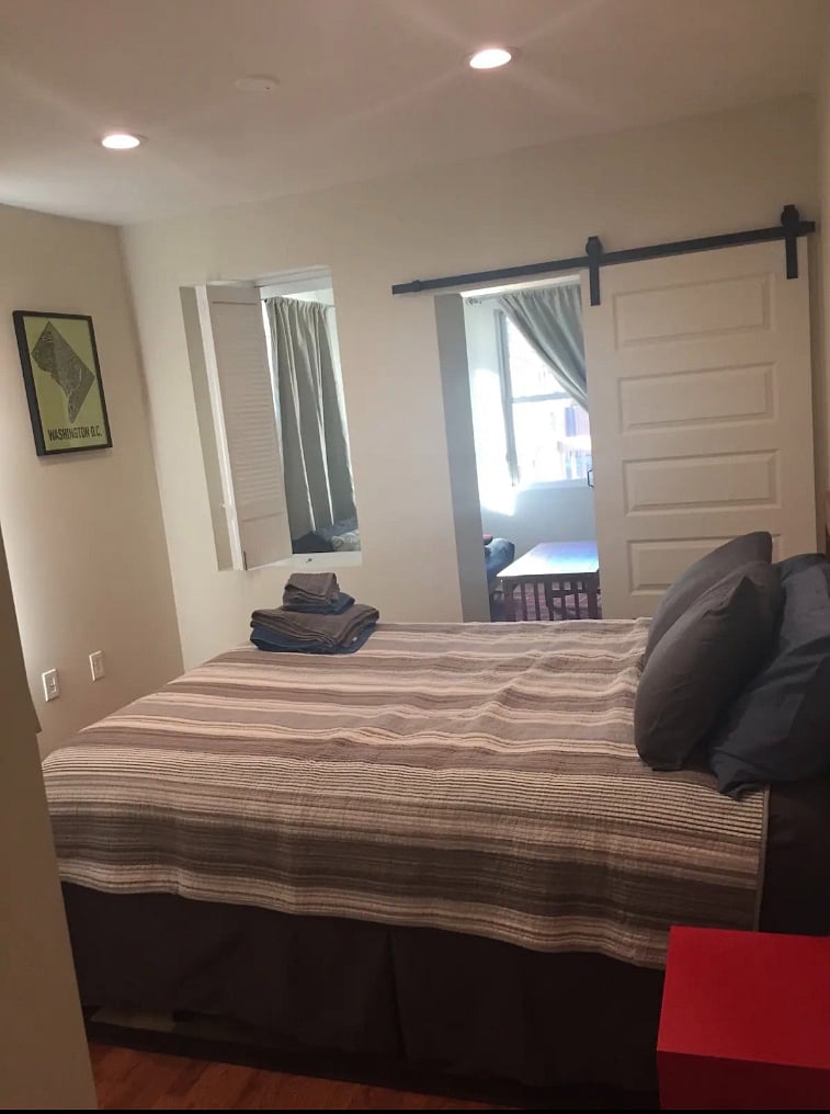 Bedroom with lockable louvered window for light and style.