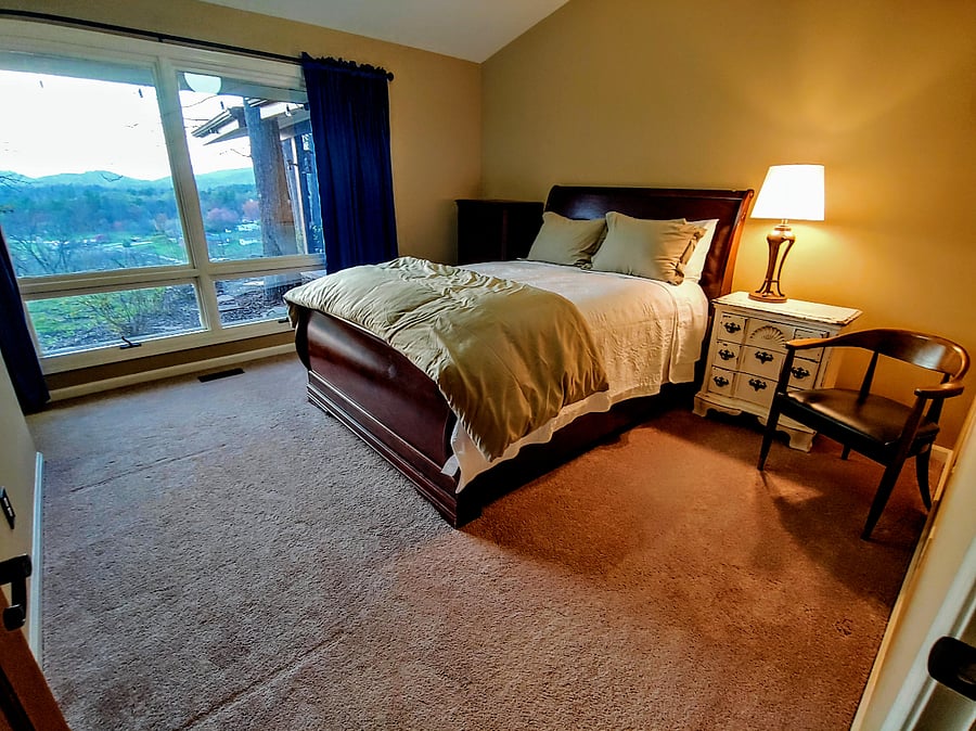 2nd bedroom with queen bed and a view