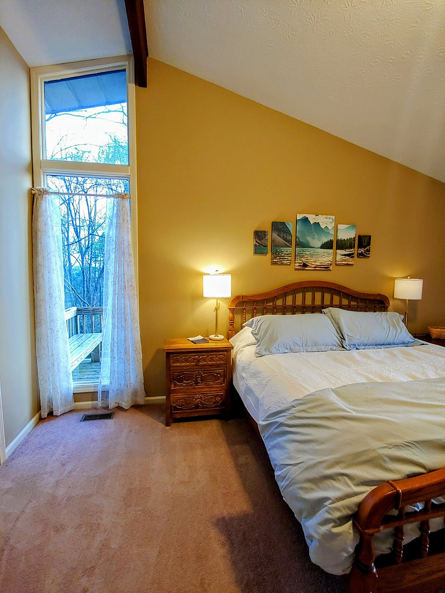 Master bedroom with king bed and a view