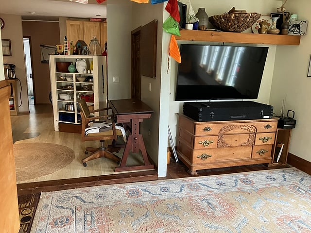 This room currently has sofa and two high back chairs.