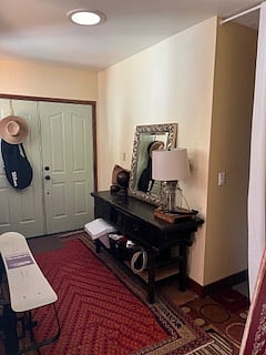Entryway adjacent to living room leads to front hall room that is currently set up as office/study for work from homers. Bed can be added back upon request.
