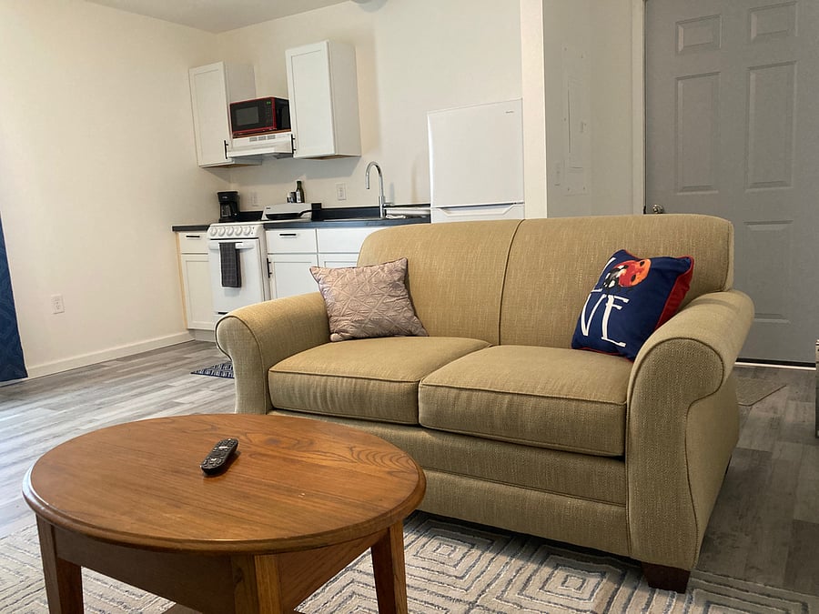 Comfy couch with smart TV remote ready for you to curl up with some popcorn!