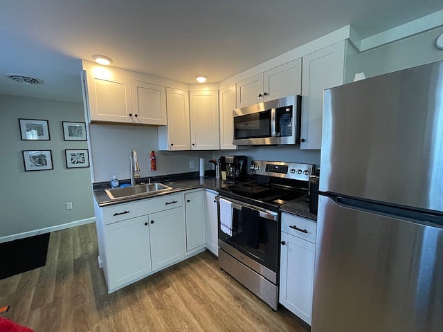 Kitchen; entrance door to left of wall pictures