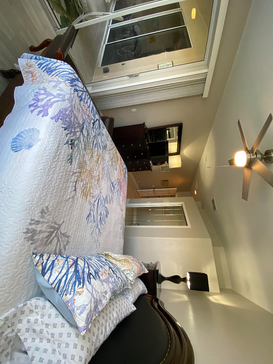Spacious Primary Bedroom with water view and sliding doors onto the Lanai. Primary bathroom. Double showers.