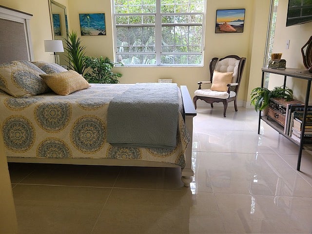 Master with queen bed and television