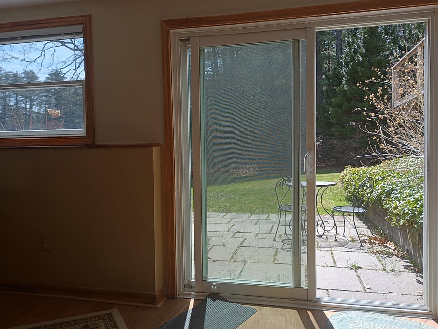 slider off tv room view of patio and bistro table
