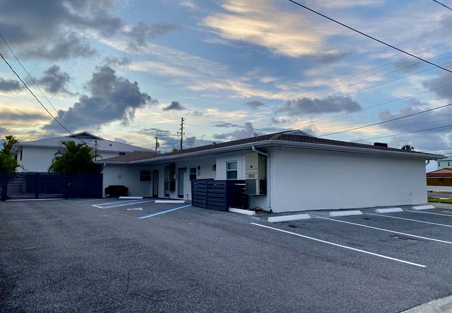Rear and side view of building and parking spaces 
