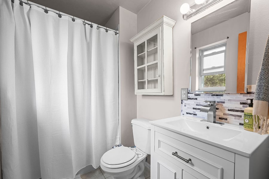The ensuite bathroom off the main bedroom offers a shower, bidet, and new vanity. 