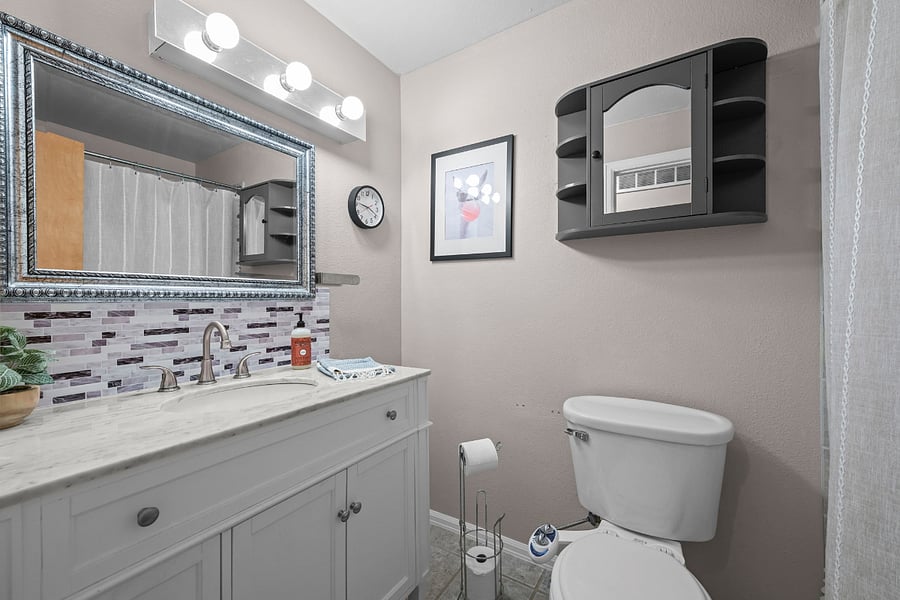 The upstairs hall bath comes with a tub and shower. A new vanity and toilet with bidet round out the space. 