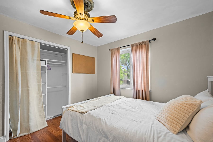 The second upstairs bedroom has a brand new Serta mattress, blackout curtains at the window overlooking our tree-lined street, and a custom closet. Warm and inviting. 