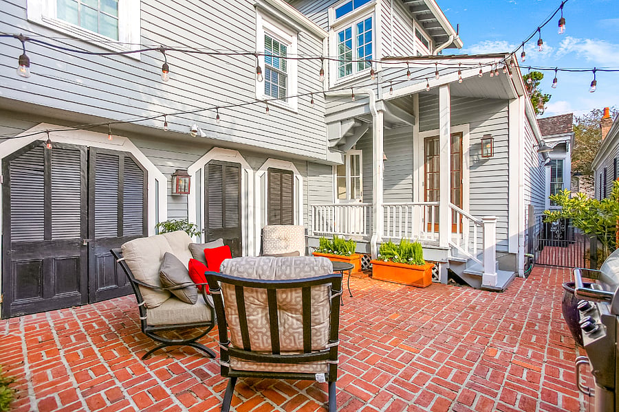 The iron gate and brick walkway lead you to the back patio and the entrance to the guest suite. The tangelo and kumquat trees hep make this spot one of our favorites.