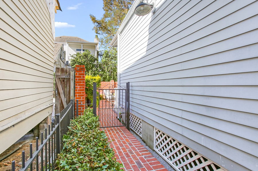 Brick walkway and iron gate that lead to the guest suite