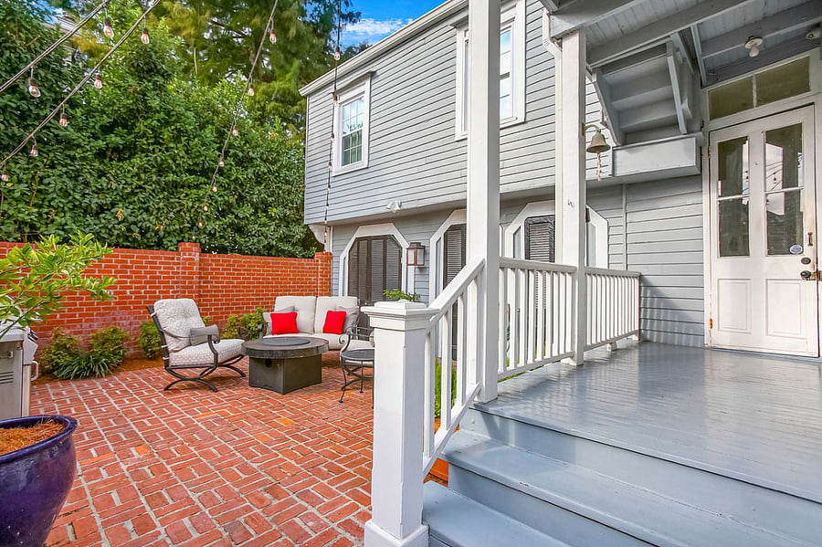 View of the brick patio from the back porch. The glass-paned door leads to the guest suite. Notice the bell, which is original to the house. Ringing is allowed!