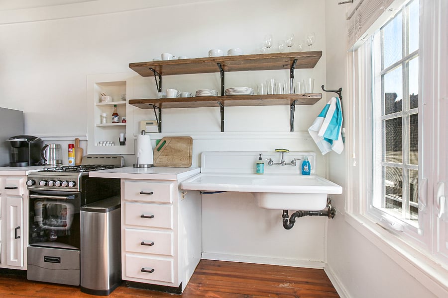 Beautiful open shelving makes plates and glasses easy to find. We love the vintage sink.