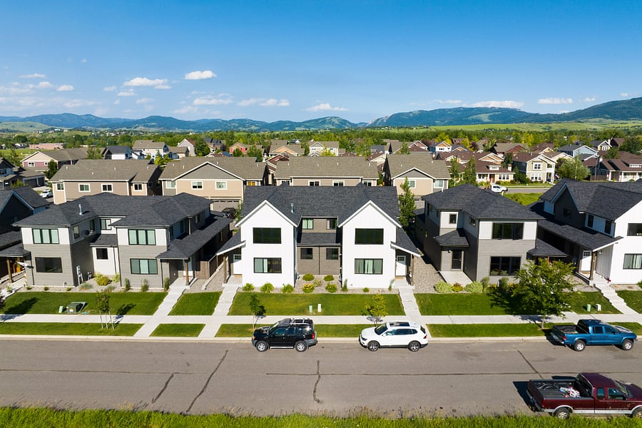 Front view. The home is on the right side of the white duplex in the center of the photo, directly behind the white car.