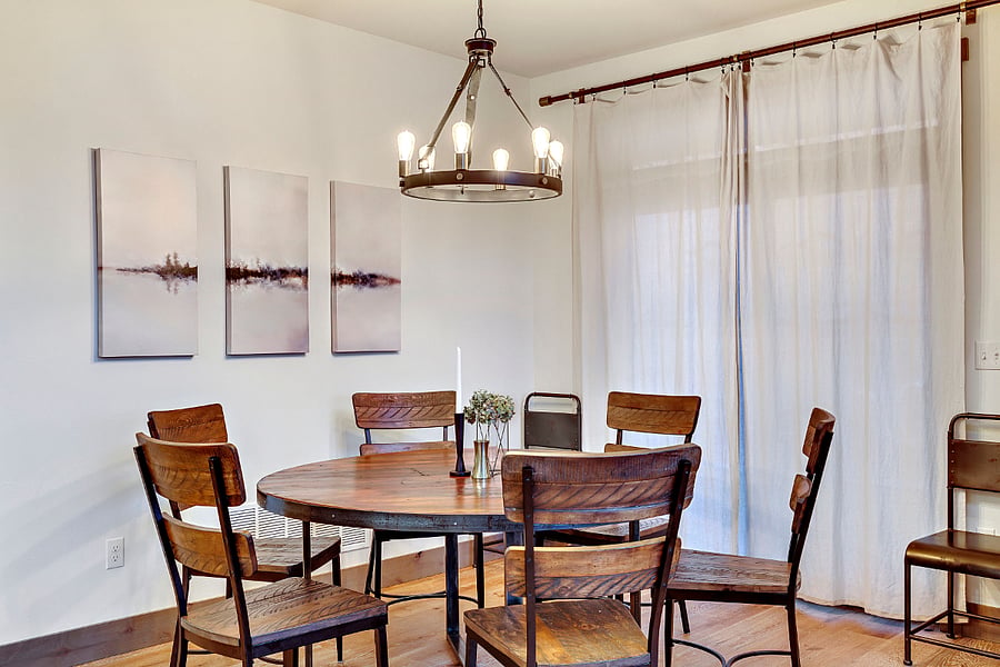 Dining area to the side of the kitchen. The windows open to a covered patio.