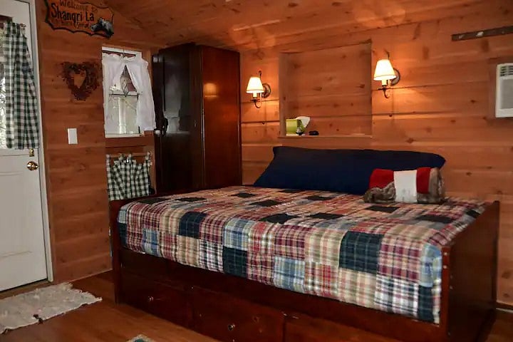 To right of Dutch door: Full bed/settee w/drawers.
"A relaxing place to come home to after a day of work."