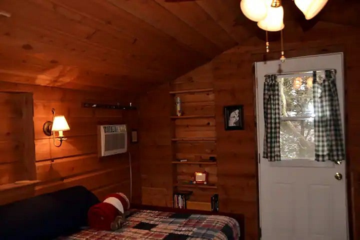 Library shelves & entry door, AC & edge of full bed / settee