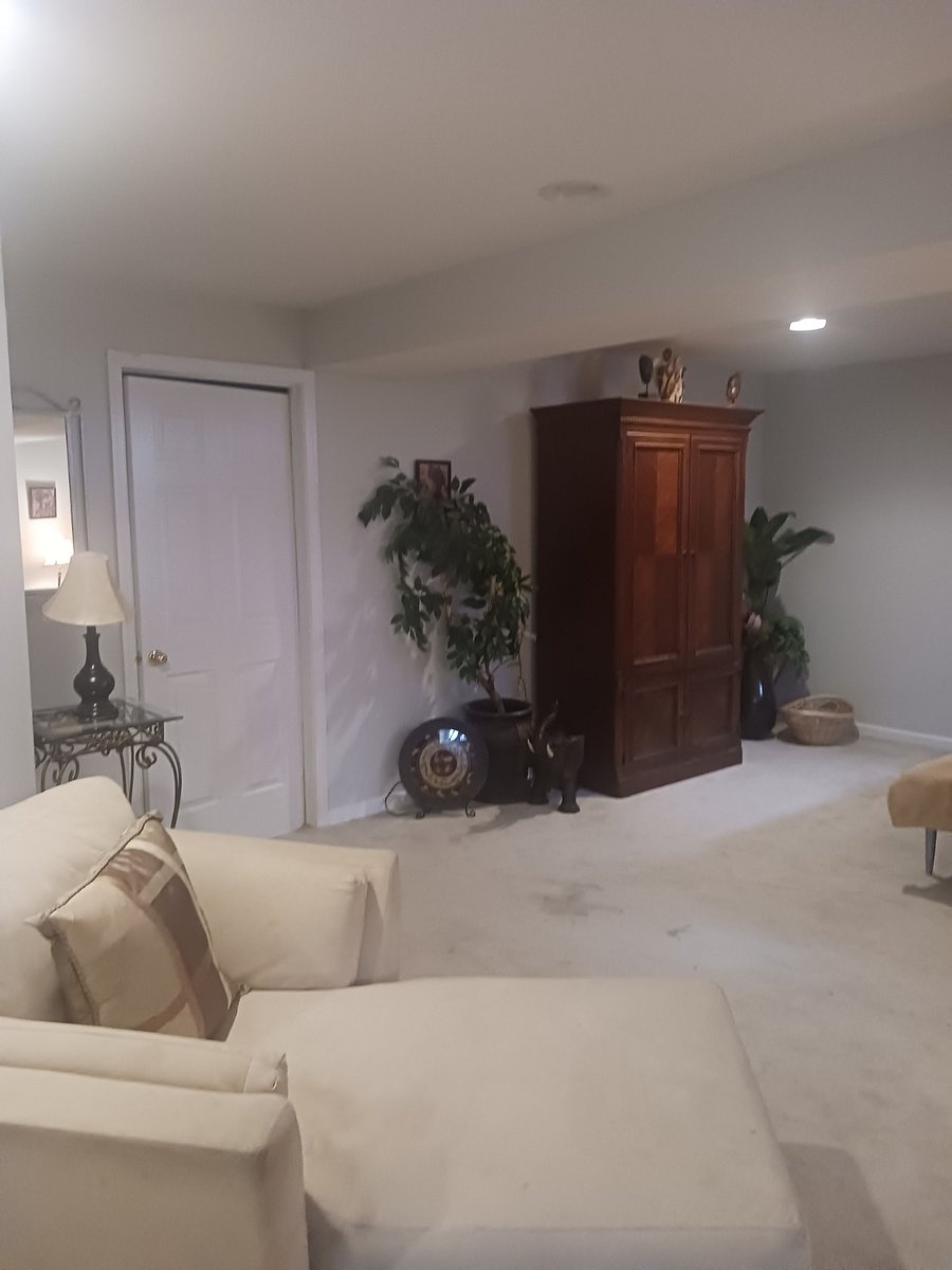 Bedroom- queen size bed, bench, nightstands, lamps, armoire and chaise lounge sitting area.