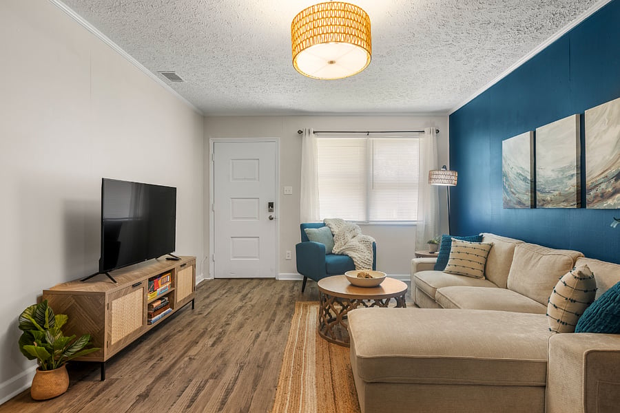 The large living area features vibrant colors, a 50" smart TV to stream your services, and room to stretch out in style.