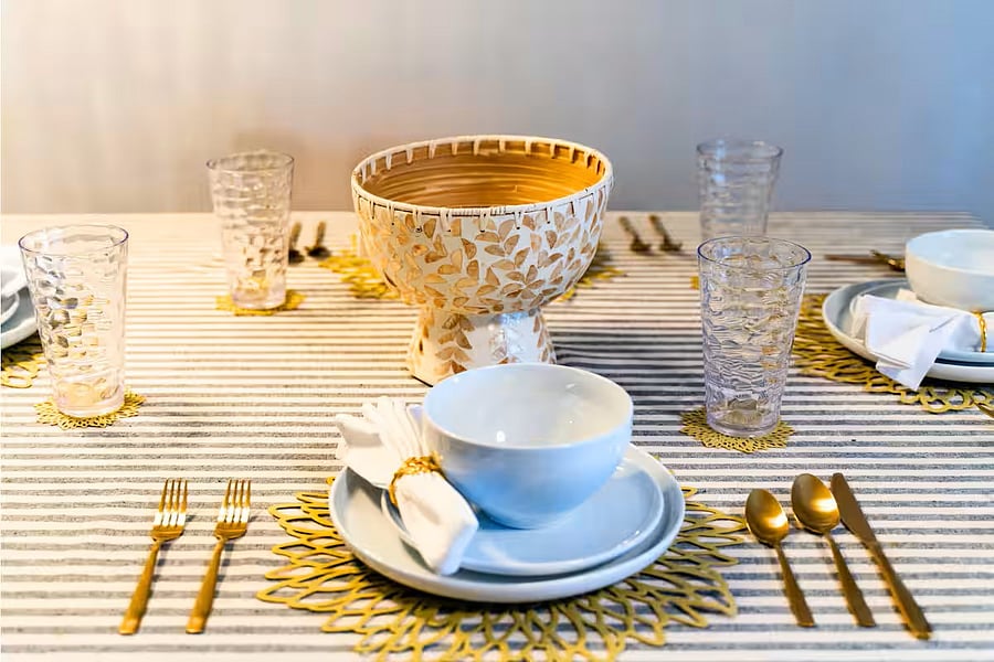 Elegant touches elevate every meal, enjoy a beautifully set table with gold accents and cozy vibes for your stay.