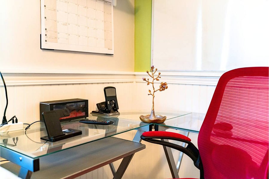 Need to get some work done? This bright and functional desk setup includes fast Wi-Fi, a comfortable chair, charging station, and a peaceful vibe to help you stay productive.
