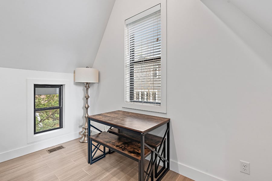 Dining Room space at top of the stairs to the right. Located behind the couch. There are additional chairs for the dining table if needed.