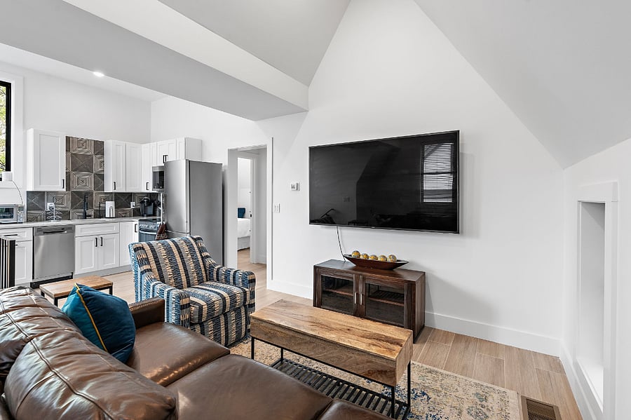 Kitchen and Living room at top of staircase. Comes with 65" smart TV.