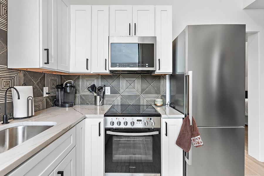 Kitchen has dishwasher, microwave, full stove and refrigerator with icemaker in bottom.