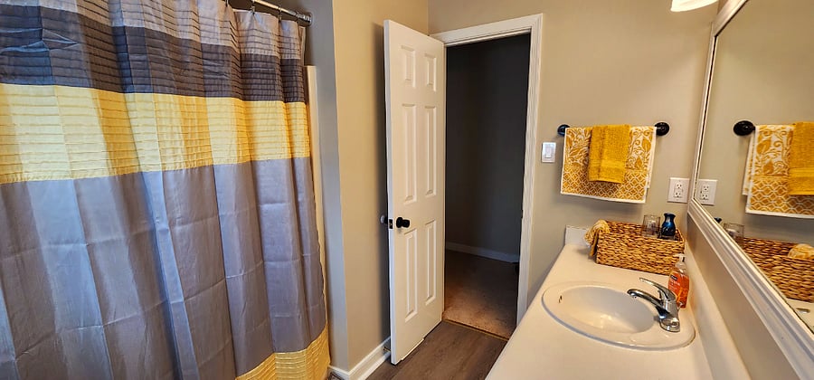 Shared bathroom with me when I come to town. Each bedroom has its own color coordinated bath towels.  