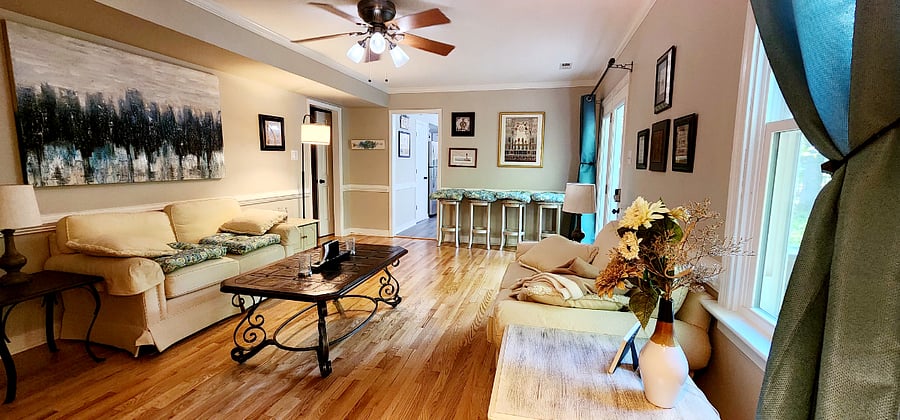 Livingroom with access to the back yard porch. This photo was taken before the live edge work station was installed. Keep looking. There is a photo coming. 