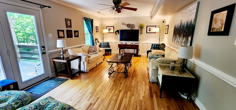 Livingroom with a large French door to the patio. I'm still working on installing a screen door. The humming birds fly right up to the glass to feed. It's truly a great place to read or bird watch.
