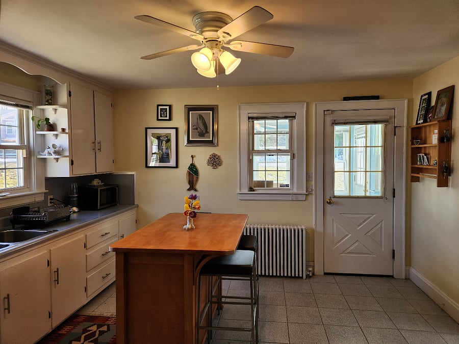 Shared first floor kitchen looking toward sun room/porch and primary entrance to the home