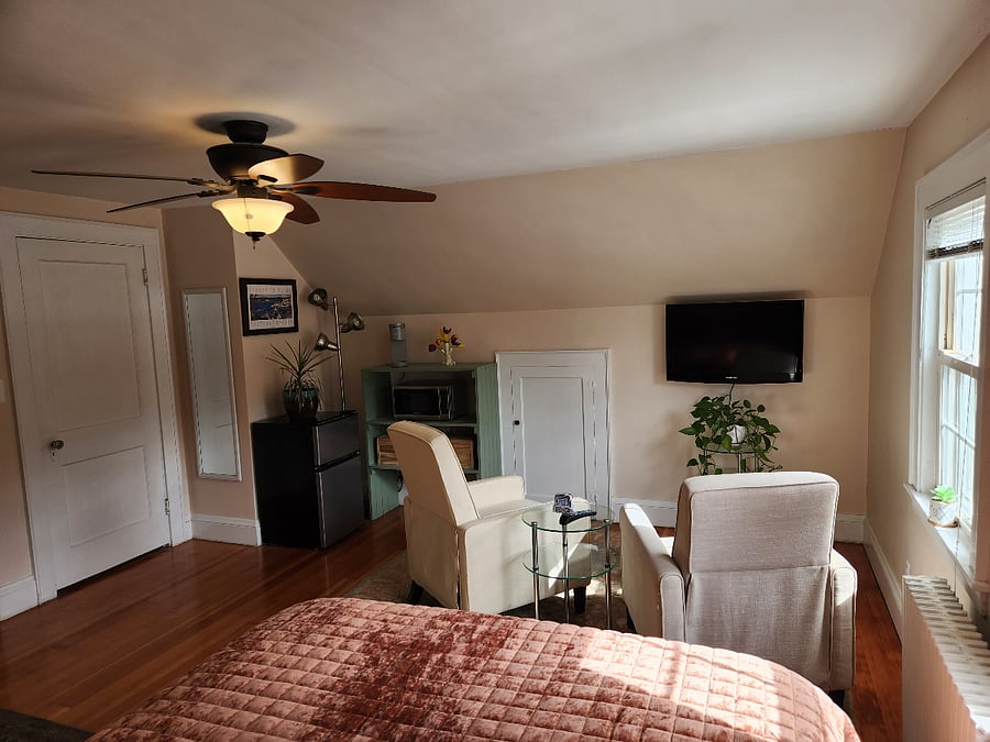 View of kitchenette, living area and full length mirror