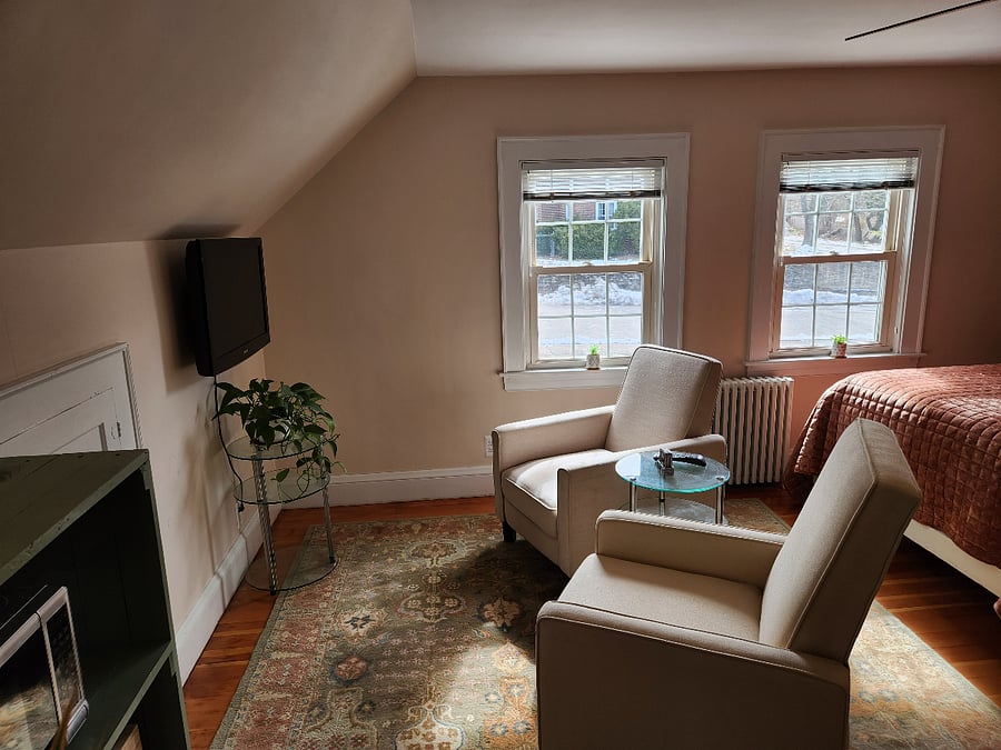 Partial studio living area with Smart TV and comfortable recliners