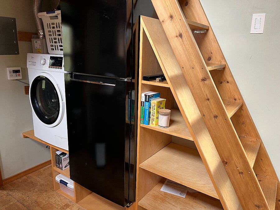 On-demand hot water heater, all-in-one laundry machine, refrigerator, storage under the stairs.