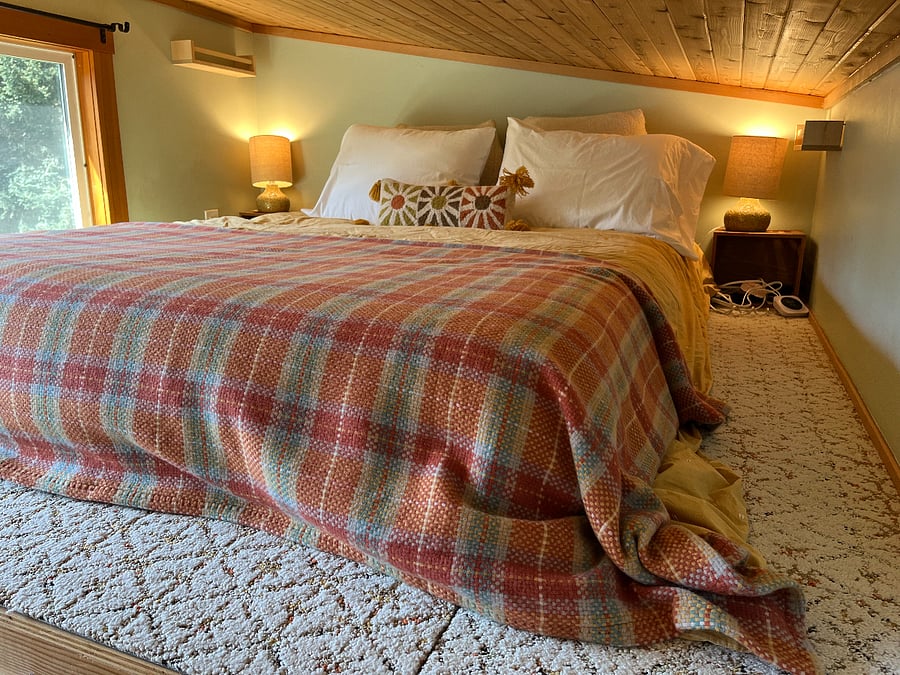 Loft bedroom, quality queen mattress, heated mattress pad with controls on both sides, view of garden.