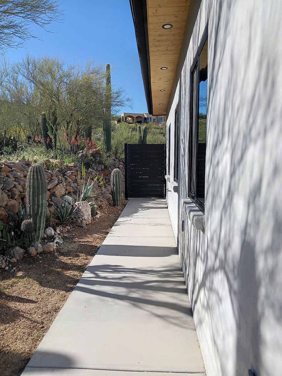 Exterior of home featuring new gates. Rear unit entrance + privacy gate